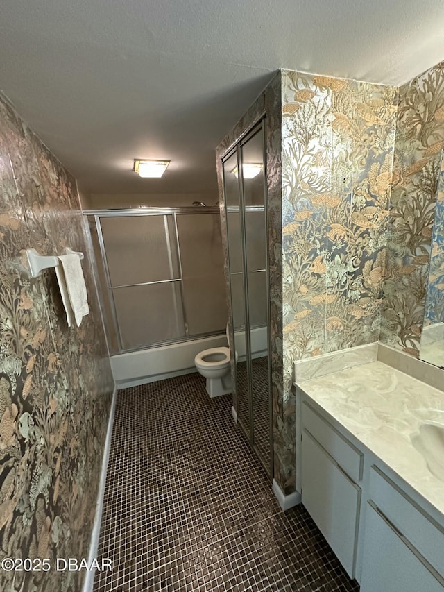 full bathroom with wallpapered walls, tile patterned floors, vanity, and a shower with door