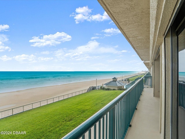 balcony with a water view and a beach view