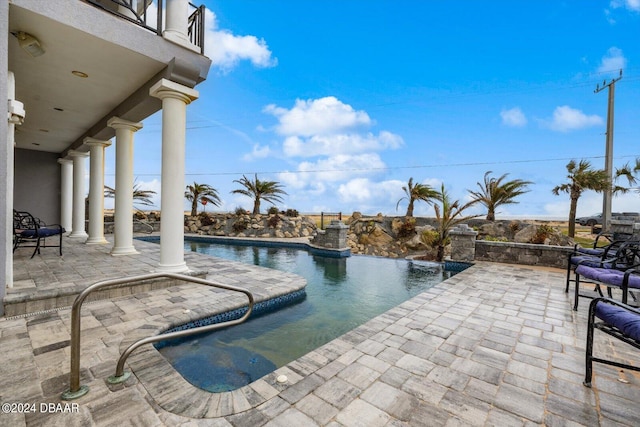 view of swimming pool featuring a patio area