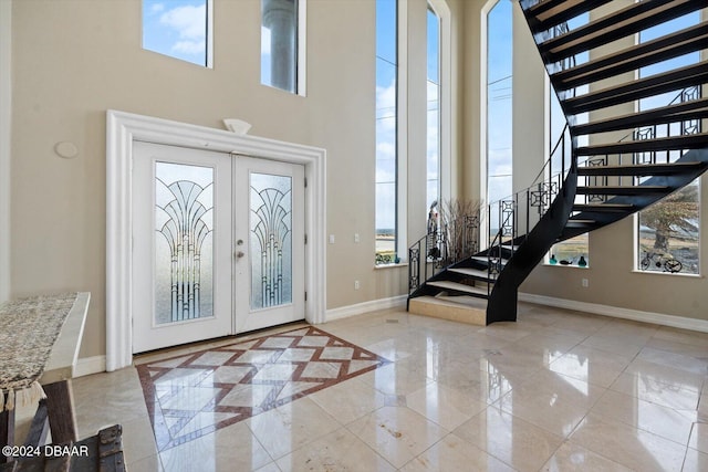 foyer featuring a high ceiling and french doors