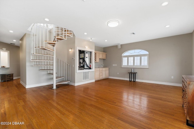 unfurnished living room with hardwood / wood-style floors