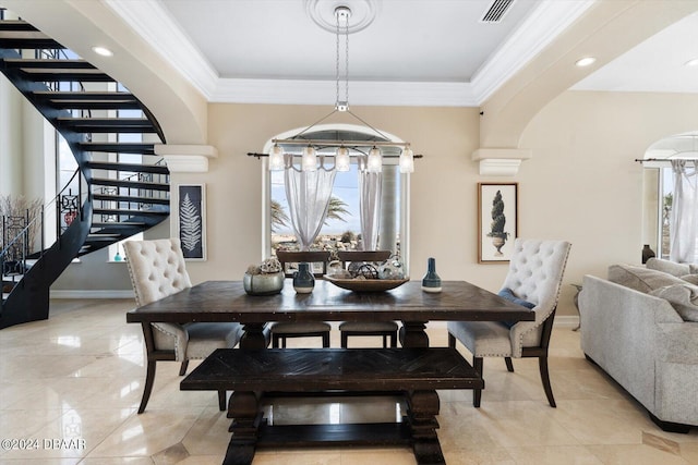 tiled dining space featuring ornamental molding and a healthy amount of sunlight