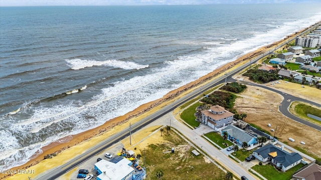 drone / aerial view with a beach view and a water view