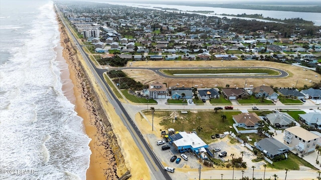 bird's eye view featuring a water view and a view of the beach