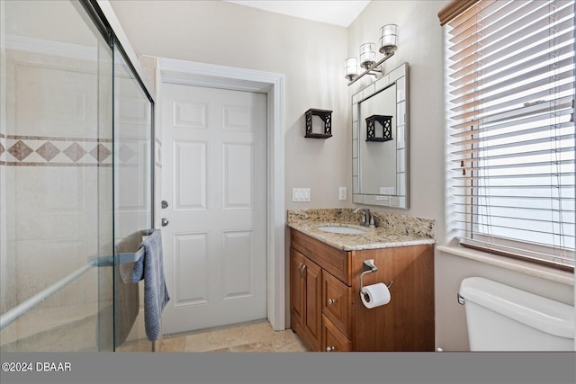 bathroom featuring vanity, walk in shower, and toilet