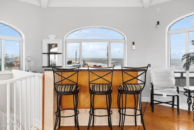 interior space with ornamental molding and hardwood / wood-style floors