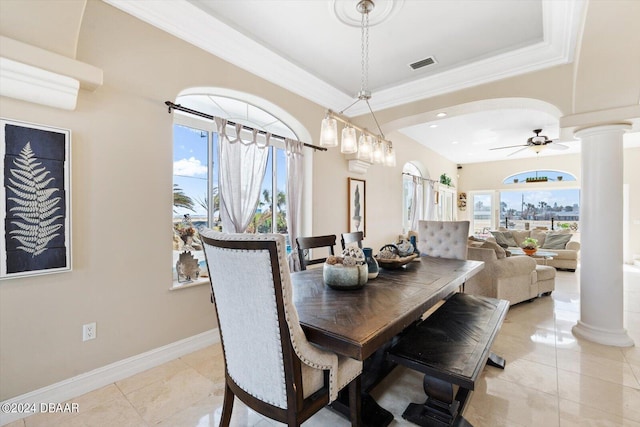 dining area with crown molding, ceiling fan, light tile patterned floors, and ornate columns