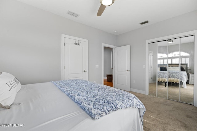 carpeted bedroom featuring ceiling fan and a closet