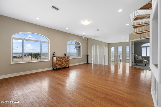 unfurnished living room with wood-type flooring