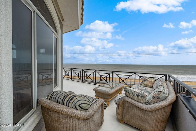 balcony with a water view and a beach view