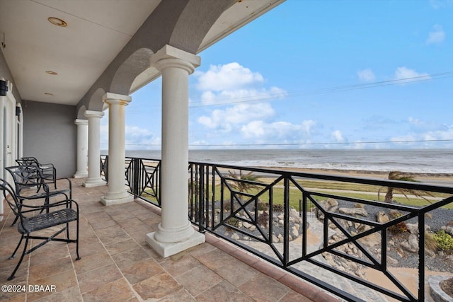 balcony with a view of the beach and a water view