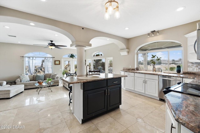 kitchen with dishwasher, sink, a wealth of natural light, and white cabinets