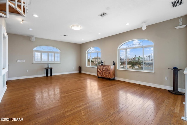 unfurnished living room with hardwood / wood-style flooring