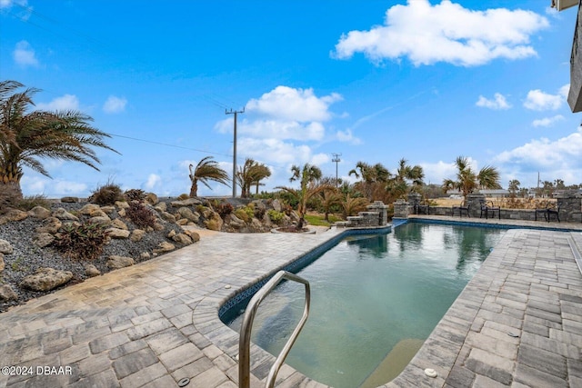 view of swimming pool with a patio area