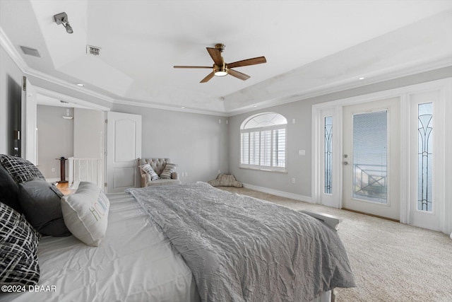 bedroom featuring ornamental molding, a tray ceiling, carpet floors, ceiling fan, and access to exterior