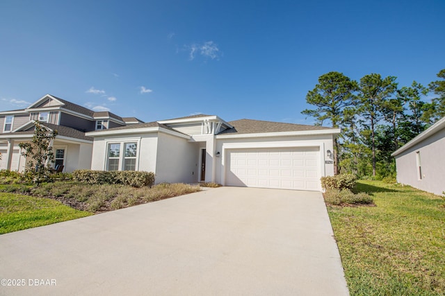 3963 Willowbrook Dr, Edgewater, FL 32141 - view of front of home with a garage, stucco siding, concrete driveway, and a front lawn