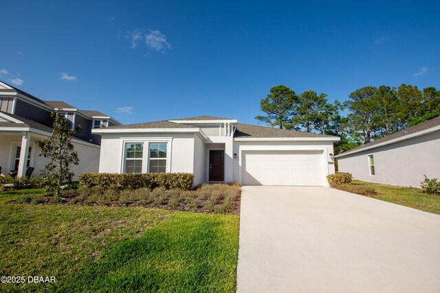 3963 Willowbrook Dr, Edgewater, FL 32141 - view of front of house with stucco siding, a garage, driveway, and a front lawn