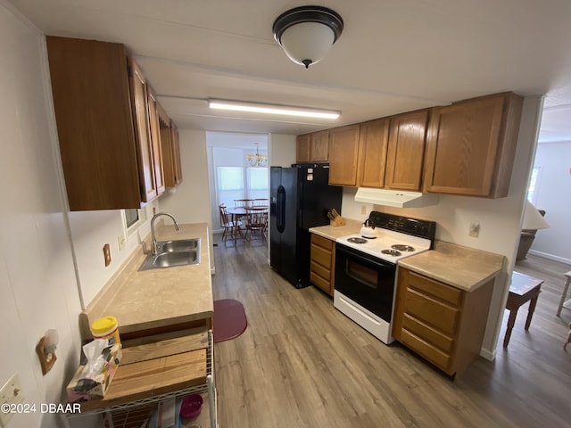 55705 Keith St, Astor, FL 32102 - kitchen featuring black refrigerator with ice dispenser, a sink, light countertops, light wood finished floors, and electric range