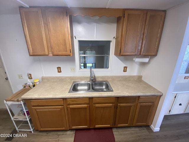55705 Keith St, Astor, FL 32102 - kitchen with dark wood-type flooring, a sink, light countertops, and brown cabinetry