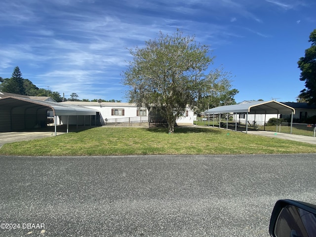 55705 Keith St, Astor, FL 32102 - manufactured / mobile home with a detached carport, driveway, and a front lawn