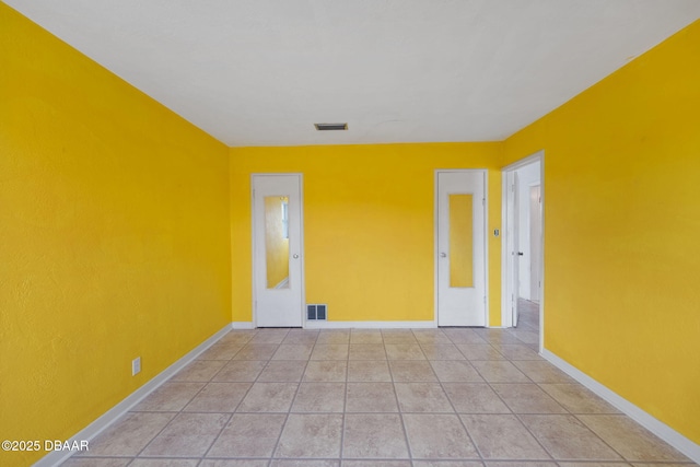 empty room with light tile patterned flooring