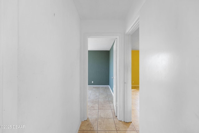 hall featuring light tile patterned flooring