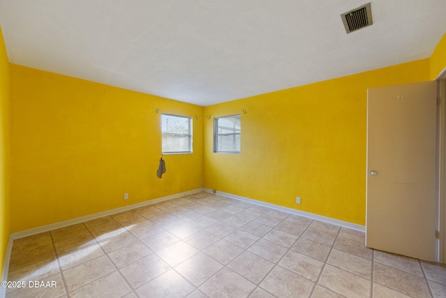 unfurnished room featuring light tile patterned floors