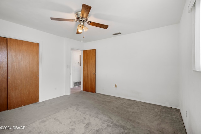 unfurnished bedroom with carpet floors, a closet, and ceiling fan