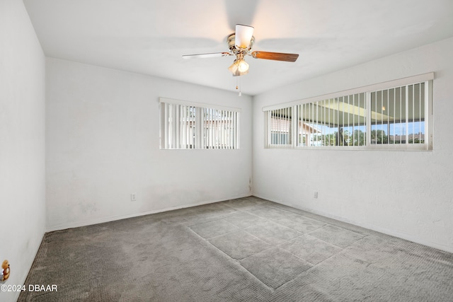 unfurnished room featuring ceiling fan and carpet floors