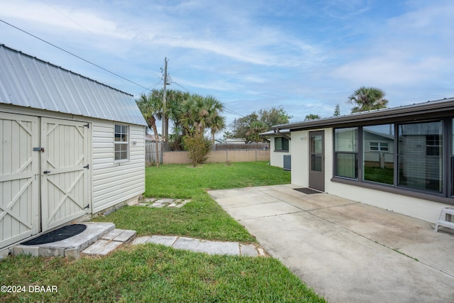 view of yard with a patio area and a storage shed