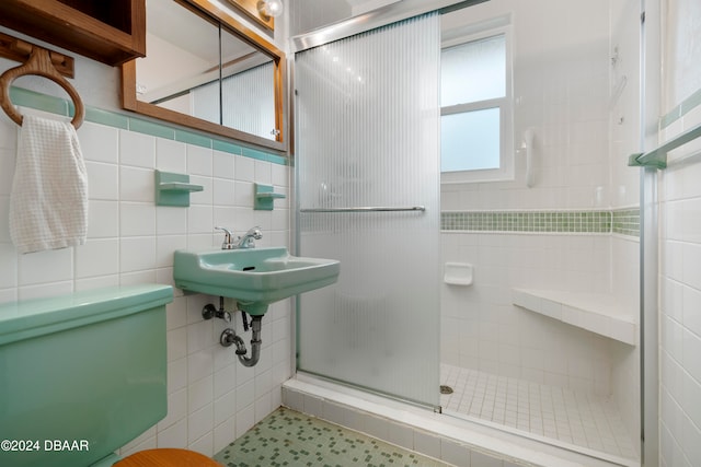 bathroom with walk in shower and tile walls