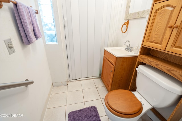 bathroom with tile patterned flooring, vanity, and toilet