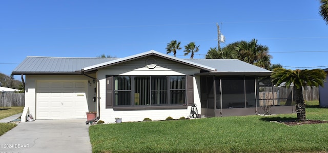 ranch-style house featuring a sunroom, a front lawn, and a garage