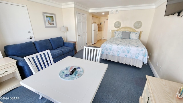 2700 N Atlantic Ave Unit 918, Daytona Beach, FL 32118 - bedroom featuring freestanding refrigerator, ornamental molding, carpet, baseboards, and recessed lighting