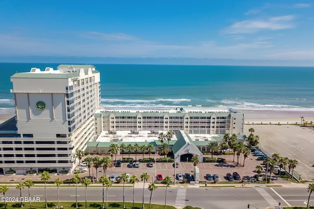 birds eye view of property featuring a beach view and a water view