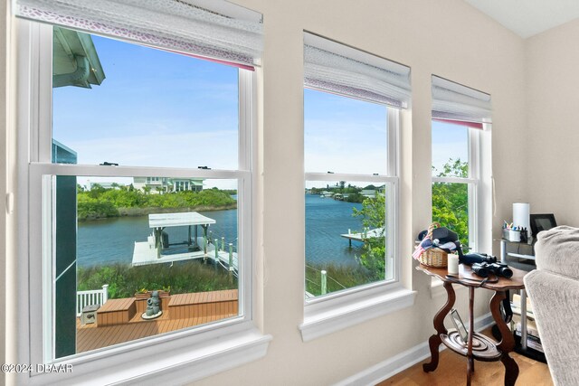 interior space with a wealth of natural light and a water view