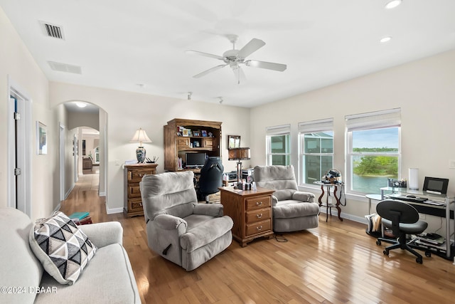 living room featuring light hardwood / wood-style floors and ceiling fan