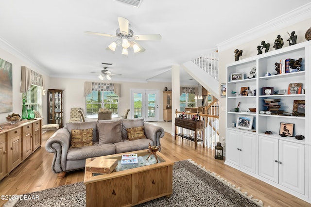 living room with ceiling fan, crown molding, and light hardwood / wood-style flooring