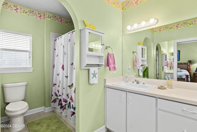 full bathroom with shower / bath combo with shower curtain, tile patterned flooring, vanity, and toilet