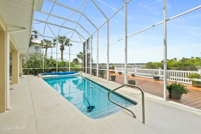 view of pool with a lanai and a deck