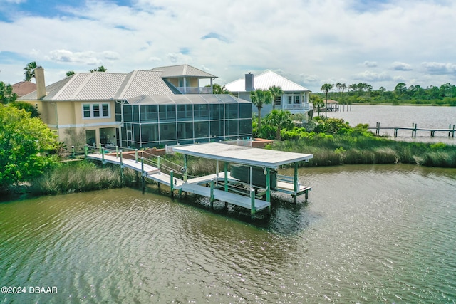 view of dock with a lanai and a water view