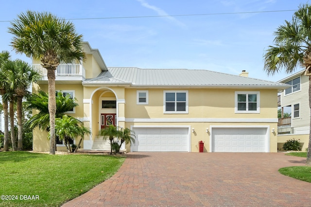 view of front of house with a garage and a front yard