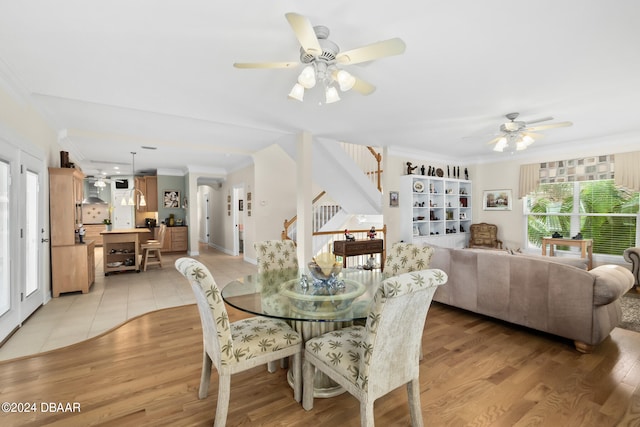 dining room featuring light hardwood / wood-style floors, ceiling fan, and crown molding