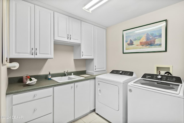 clothes washing area with cabinets, sink, washer and dryer, and light tile patterned floors