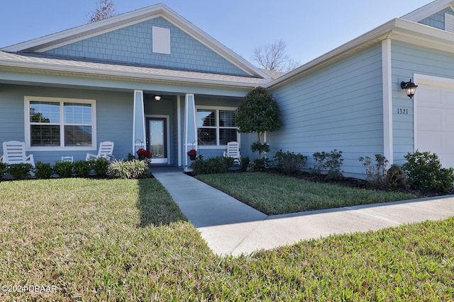 view of front of property with a garage and a front lawn