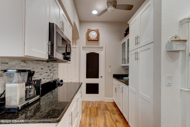 3102 N Springwater Ct N, Port Orange, FL 32128 - kitchen with stainless steel microwave, tasteful backsplash, a ceiling fan, white cabinetry, and light wood finished floors