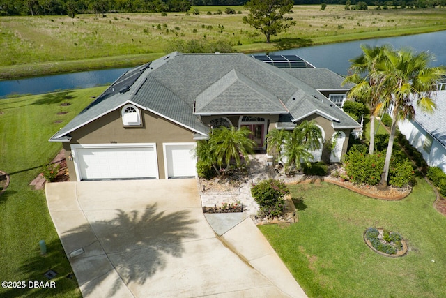 3102 N Springwater Ct N, Port Orange, FL 32128 - view of front of property featuring a water view, concrete driveway, stucco siding, and roof with shingles