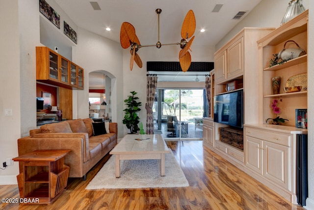 3102 N Springwater Ct N, Port Orange, FL 32128 - living room with arched walkways, light wood-style floors, ceiling fan, and recessed lighting