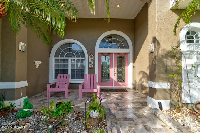 3102 N Springwater Ct N, Port Orange, FL 32128 - property entrance featuring stucco siding, french doors, and a porch