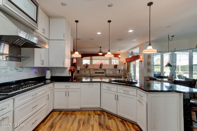 3102 N Springwater Ct N, Port Orange, FL 32128 - kitchen with stainless steel gas stovetop, ventilation hood, open floor plan, decorative backsplash, and healthy amount of natural light